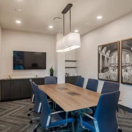 conference room with a large table and chairs and a tv